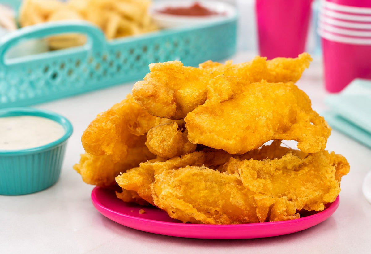 A plate of tempura chicken fingers with ranch