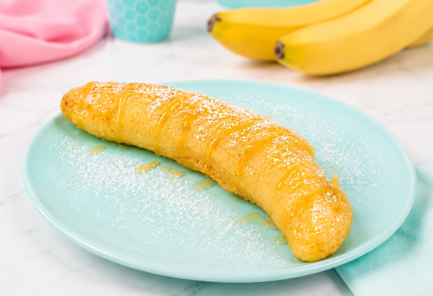 Whole tempura fried banana drizzled with honey and dusted with powdered sugar